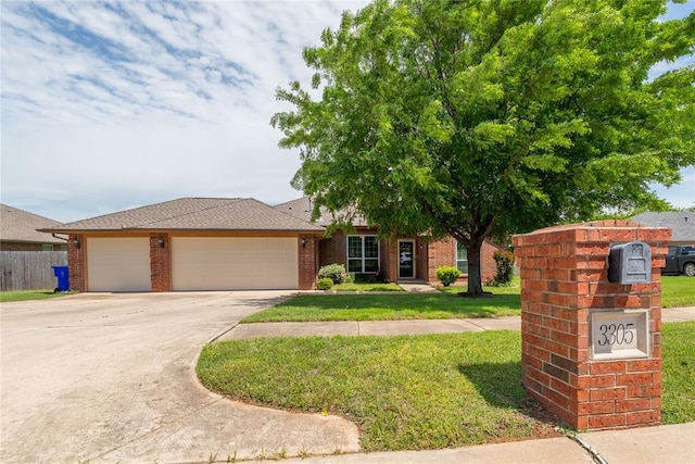 3305 Tecumseh Meadows Way, Norman, OK 73069 - view of front facade with a garage, driveway, and brick siding