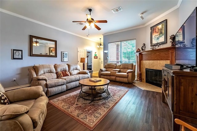 3305 Tecumseh Meadows Way, Norman, OK 73069 - living room featuring a ceiling fan, dark wood-style floors, a tiled fireplace, ornamental molding, and baseboards
