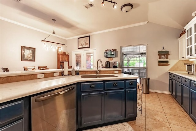 3305 Tecumseh Meadows Way, Norman, OK 73069 - kitchen with dishwasher, a sink, light countertops, light tile patterned floors, and crown molding