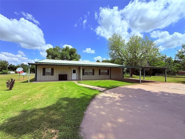 312 N 6th St, Amber, OK 73004 - single story home featuring board and batten siding, a front yard, driveway, and a carport