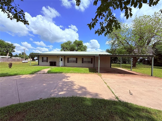 312 N 6th St, Amber, OK 73004 - view of front of home with an attached carport, driveway, metal roof, and board and batten siding