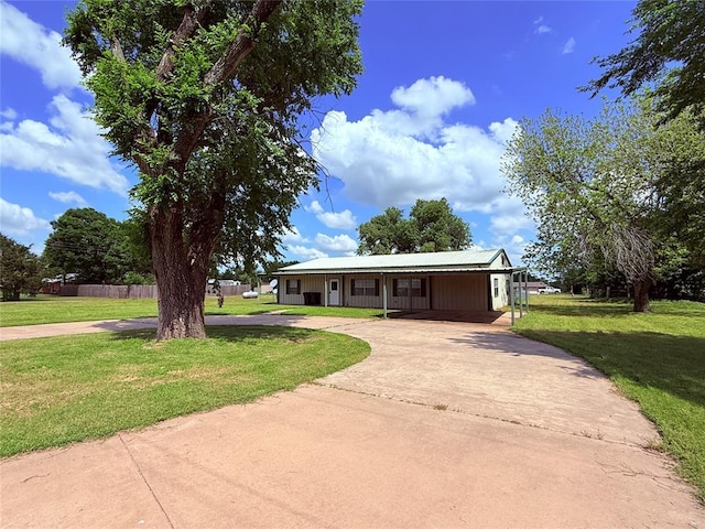 312 N 6th St, Amber, OK 73004 - single story home featuring concrete driveway, a front lawn, a carport, and metal roof