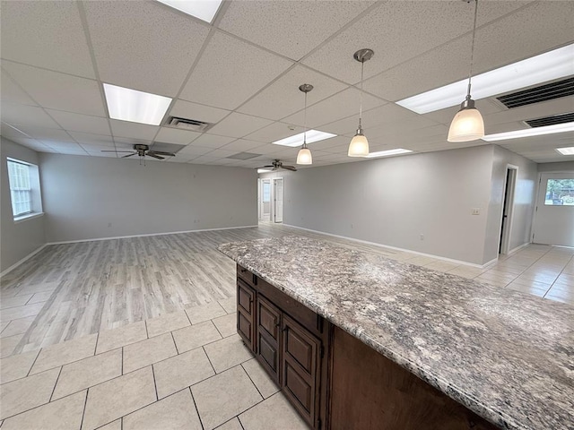 312 N 6th St, Amber, OK 73004 - kitchen with ceiling fan, decorative light fixtures, dark brown cabinetry, open floor plan, and a paneled ceiling