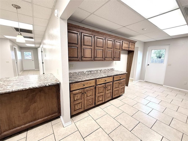 312 N 6th St, Amber, OK 73004 - kitchen with a drop ceiling, pendant lighting, baseboards, healthy amount of natural light, and light stone countertops