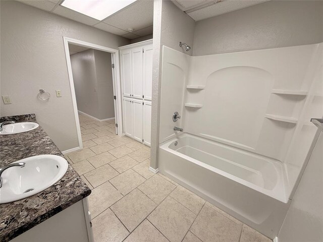 312 N 6th St, Amber, OK 73004 - bathroom with shower / bath combination, tile patterned floors, double vanity, baseboards, and a textured wall