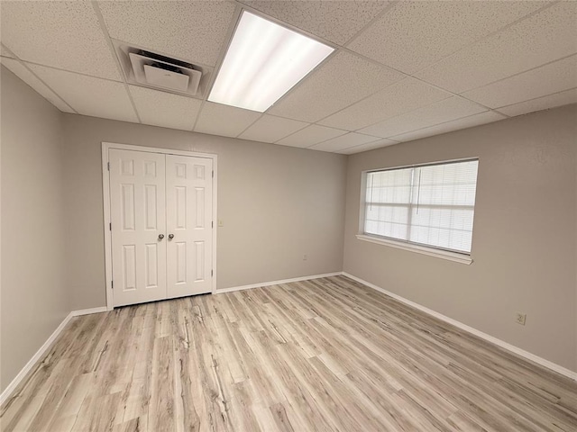 312 N 6th St, Amber, OK 73004 - spare room with a paneled ceiling, light wood-style floors, and baseboards