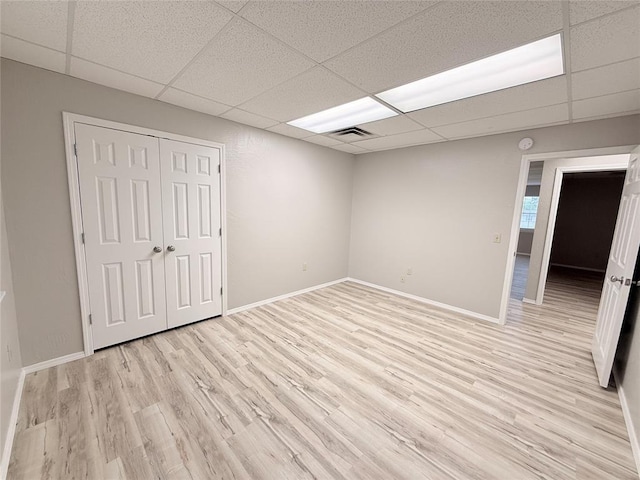 312 N 6th St, Amber, OK 73004 - unfurnished room with a paneled ceiling, light wood finished floors, and baseboards