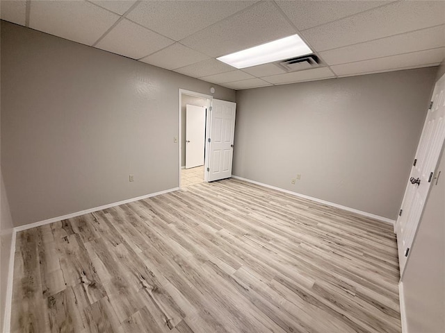 312 N 6th St, Amber, OK 73004 - unfurnished room with a drop ceiling, light wood-style flooring, and baseboards