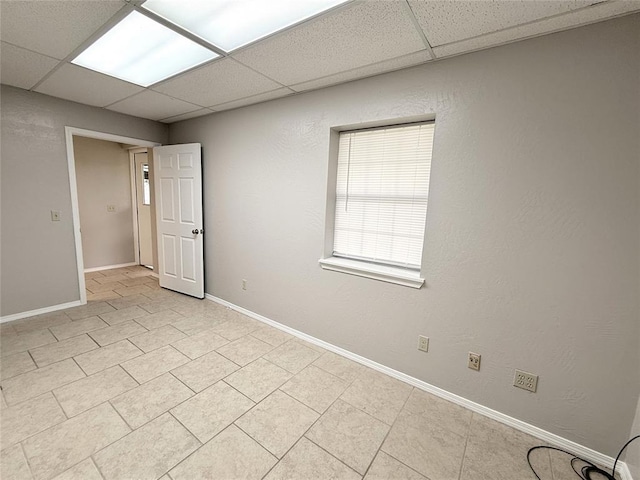 312 N 6th St, Amber, OK 73004 - unfurnished room with a drop ceiling, baseboards, and light tile patterned flooring