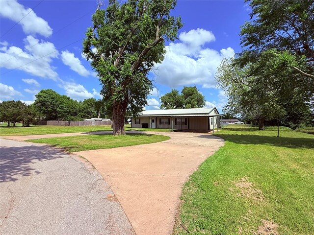 312 N 6th St, Amber, OK 73004 - view of front of house featuring driveway and an attached carport