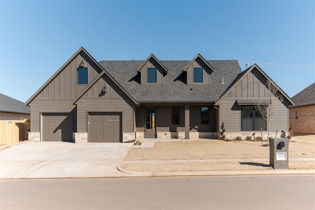 9213 NW 85th St, Yukon, OK 73099 - view of front of house featuring board and batten siding, a garage, concrete driveway, roof with shingles, and a porch