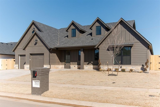 9213 NW 85th St, Yukon, OK 73099 - view of front of home featuring board and batten siding, concrete driveway, a shingled roof, and covered porch