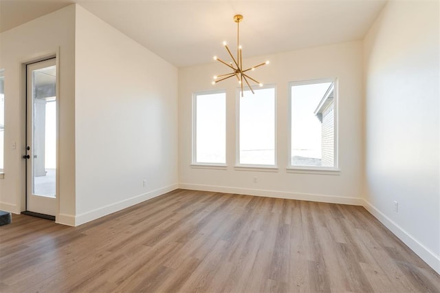 9213 NW 85th St, Yukon, OK 73099 - unfurnished dining area featuring a chandelier, light wood-style floors, and baseboards