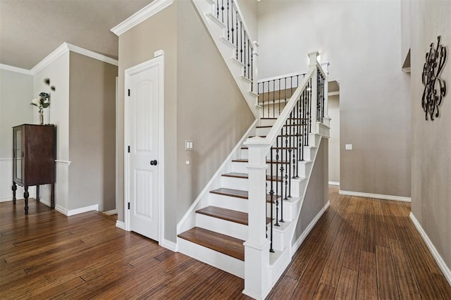 7941 E Sorghum Mill Rd, Edmond, OK 73034 - stairway with ornamental molding, wood finished floors, and baseboards