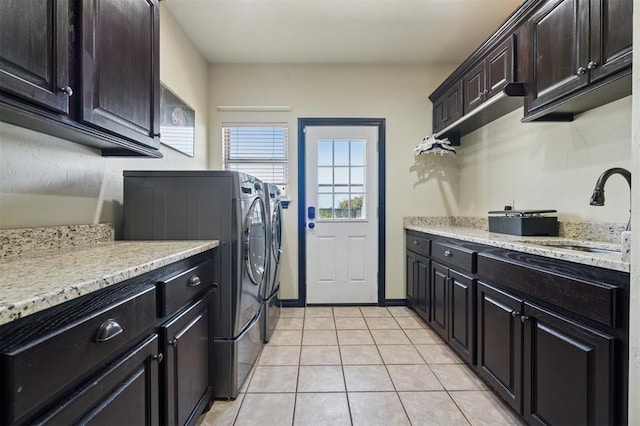 7941 E Sorghum Mill Rd, Edmond, OK 73034 - washroom with independent washer and dryer, cabinet space, and light tile patterned floors