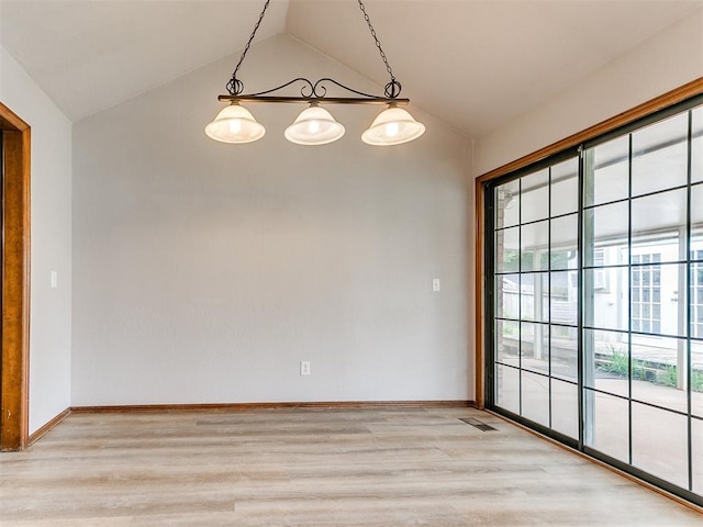 unfurnished dining area with vaulted ceiling, light wood-style flooring, and baseboards