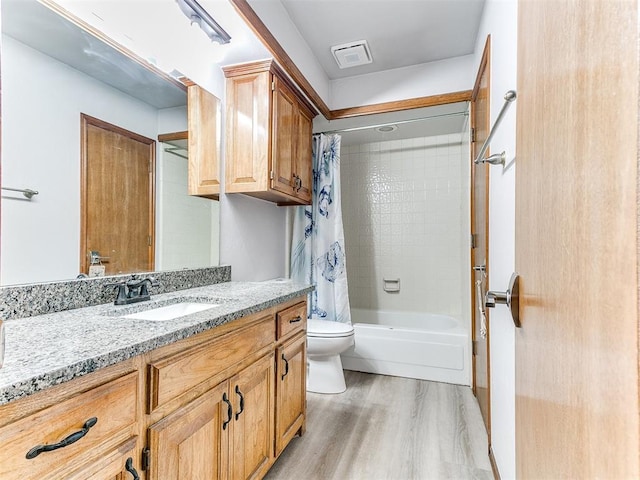 full bathroom with wood finished floors, vanity, toilet, and shower / bath combo with shower curtain