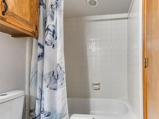 bathroom with toilet and shower / bath combination with curtain