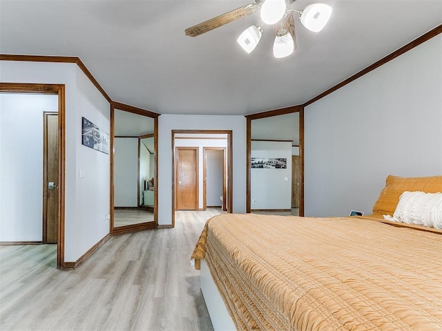 bedroom with ornamental molding, light wood-type flooring, baseboards, and a ceiling fan