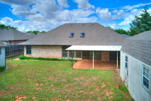 back of property featuring a patio, brick siding, and a shingled roof