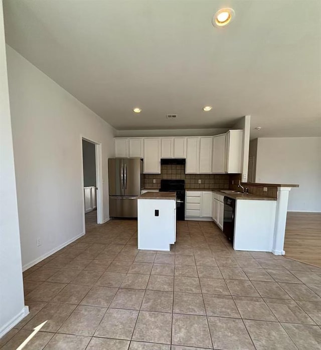 1918 W K Ct, Jenks, OK 74037 - kitchen with black appliances, a center island, backsplash, white cabinets, and dark countertops