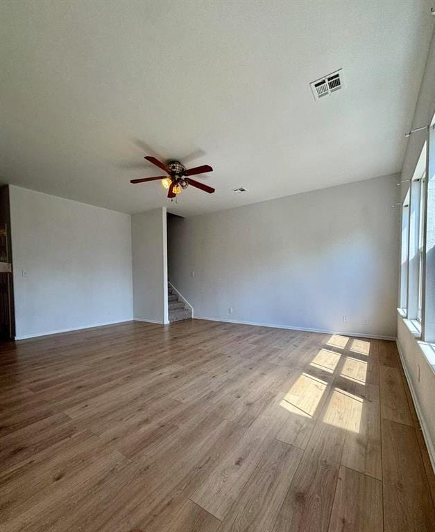1918 W K Ct, Jenks, OK 74037 - empty room featuring wood finished floors, ceiling fan, and stairs