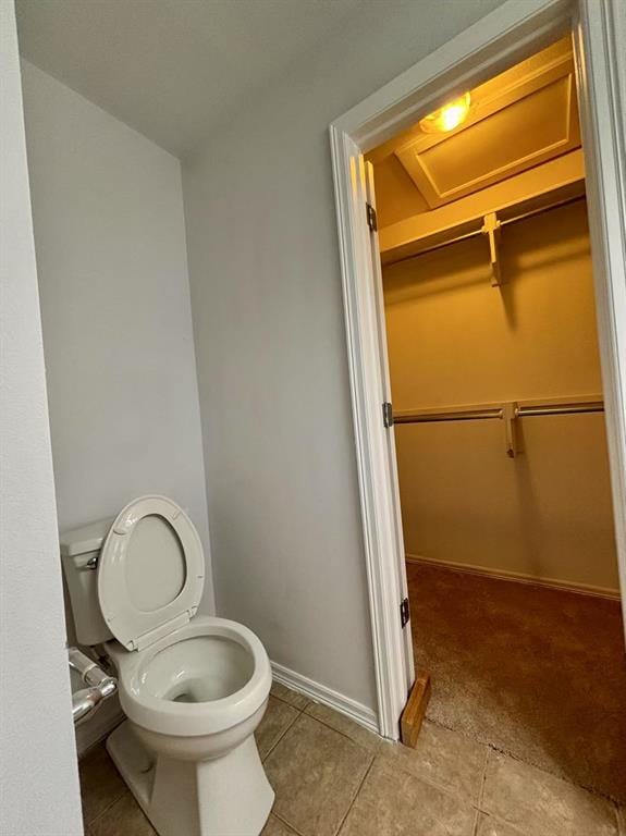 1918 W K Ct, Jenks, OK 74037 - bathroom with toilet, tile patterned flooring, baseboards, and a walk in closet