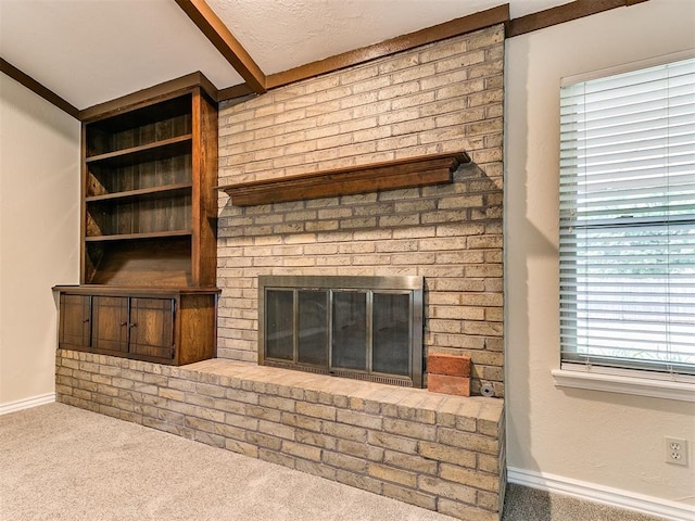unfurnished living room with carpet, a fireplace, and baseboards