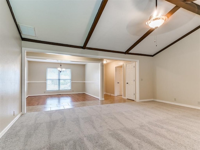 spare room with carpet flooring, baseboards, a ceiling fan, and a chandelier