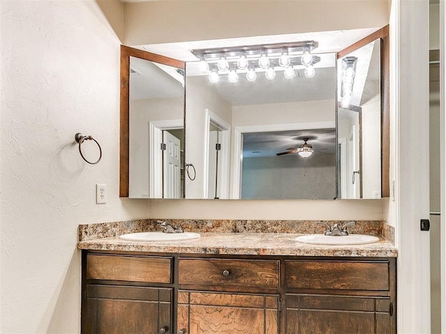 full bathroom featuring double vanity and ceiling fan