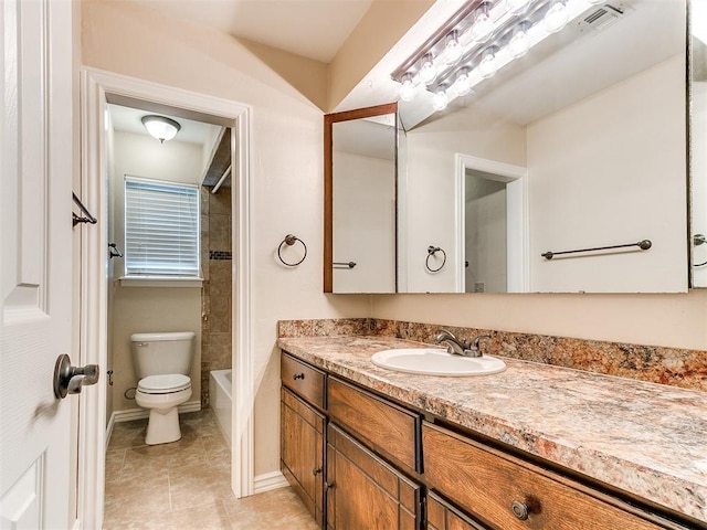 bathroom with toilet, vanity, tile patterned flooring, and washtub / shower combination