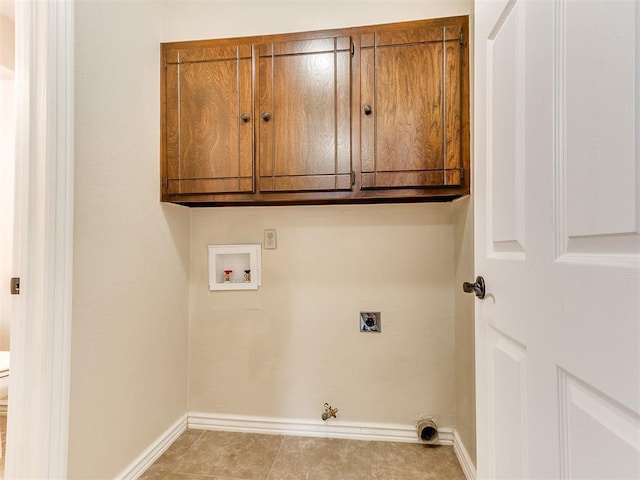 clothes washing area featuring hookup for an electric dryer, washer hookup, cabinet space, baseboards, and hookup for a gas dryer