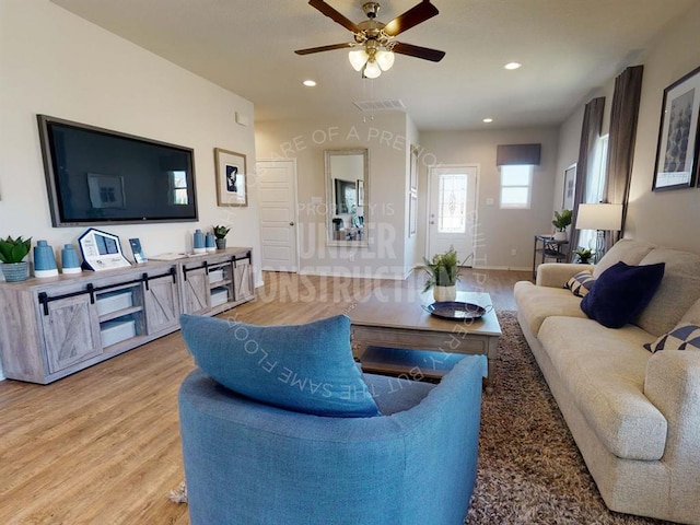 living area featuring light wood-style flooring, ceiling fan, and recessed lighting