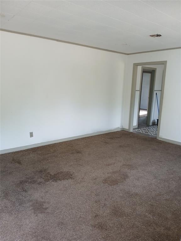 spare room with carpet floors and baseboards