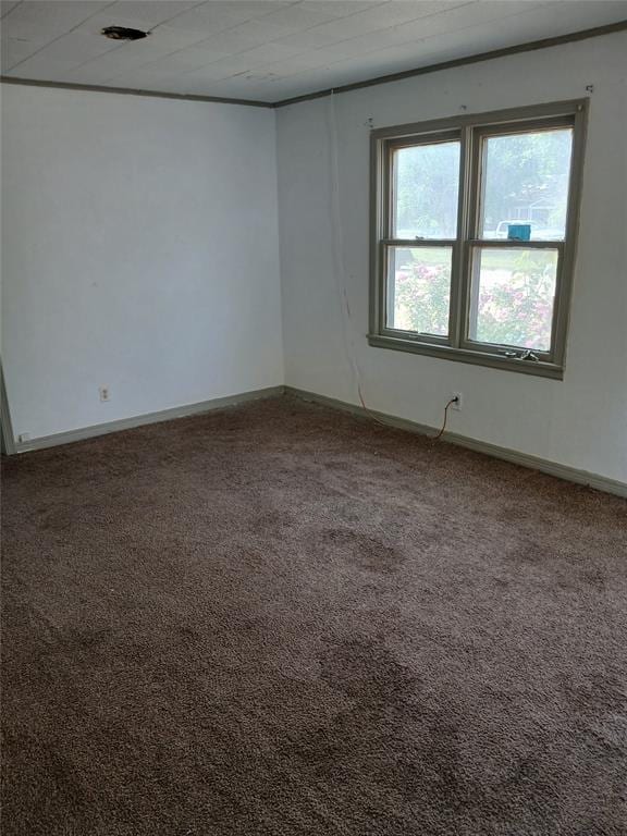 carpeted empty room with baseboards