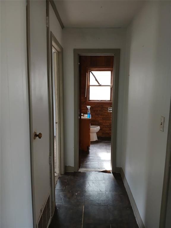 hall featuring baseboards