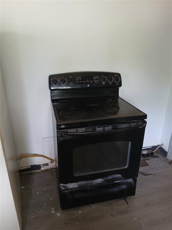 detailed view of electric range and wood finished floors