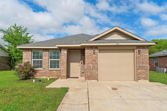 717 S Geronimo Ln, Pauls Valley, OK 73075 - ranch-style house featuring brick siding, concrete driveway, a front lawn, an attached garage, and central AC