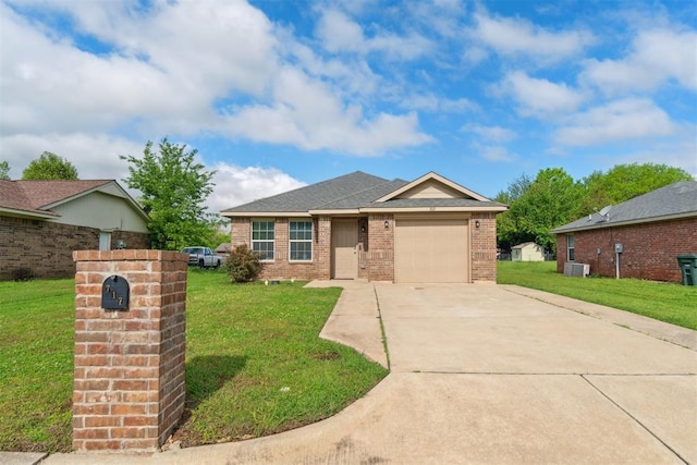 717 S Geronimo Ln, Pauls Valley, OK 73075 - view of front facade with brick siding, an attached garage, driveway, a front yard, and central AC