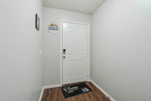 717 S Geronimo Ln, Pauls Valley, OK 73075 - doorway featuring dark wood-style floors and baseboards
