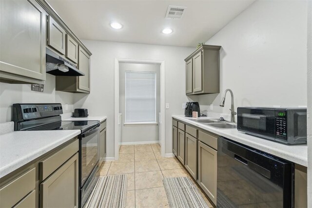 717 S Geronimo Ln, Pauls Valley, OK 73075 - kitchen featuring black appliances, a sink, under cabinet range hood, light countertops, and light tile patterned flooring