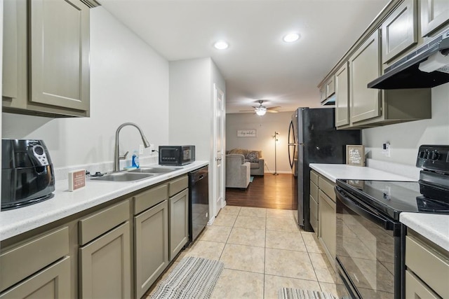 717 S Geronimo Ln, Pauls Valley, OK 73075 - kitchen featuring black appliances, a sink, under cabinet range hood, light countertops, and a ceiling fan