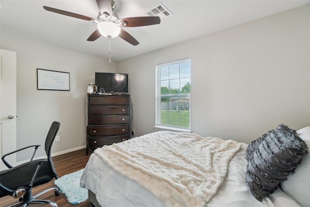 717 S Geronimo Ln, Pauls Valley, OK 73075 - bedroom with dark wood-type flooring, baseboards, and a ceiling fan