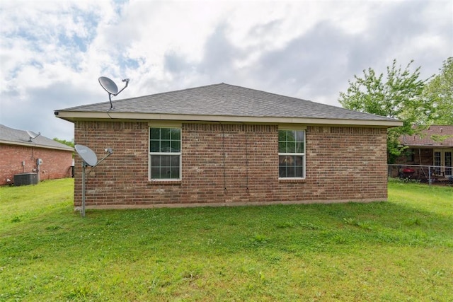 717 S Geronimo Ln, Pauls Valley, OK 73075 - back of property featuring a yard, brick siding, and roof with shingles