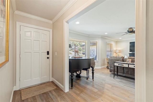 foyer with light wood finished floors, baseboards, a ceiling fan, recessed lighting, and ornamental molding
