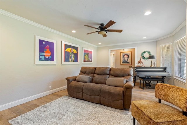 living room with a ceiling fan, recessed lighting, light wood-type flooring, baseboards, and crown molding