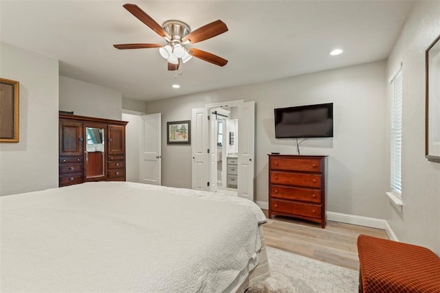 bedroom with light wood-style flooring, recessed lighting, baseboards, a ceiling fan, and ensuite bath