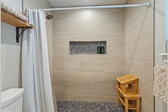 full bath with a stall shower and toilet