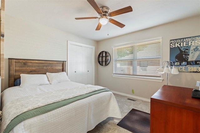 bedroom featuring carpet flooring, baseboards, a ceiling fan, and a closet
