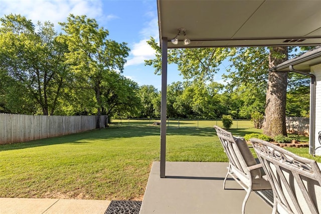 view of yard with a patio and view of wooded area